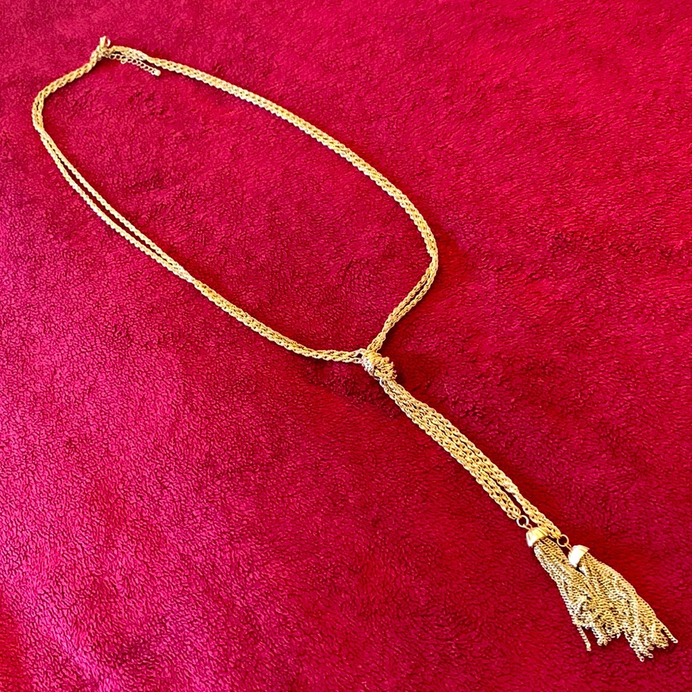 Gold tone necklace with drop tassel accent